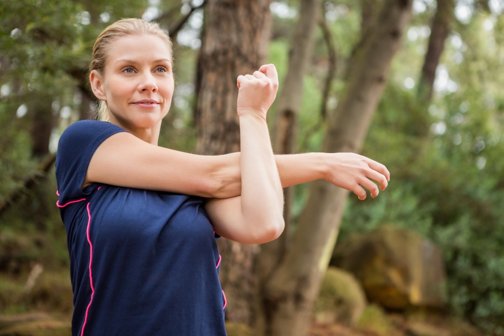 Athletic blonde stretching arms