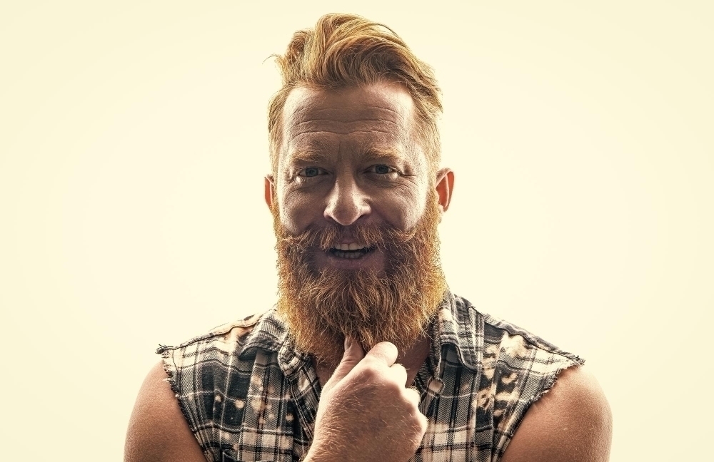 Happy brutal bearded man isolated on white brutal bearded man in studio