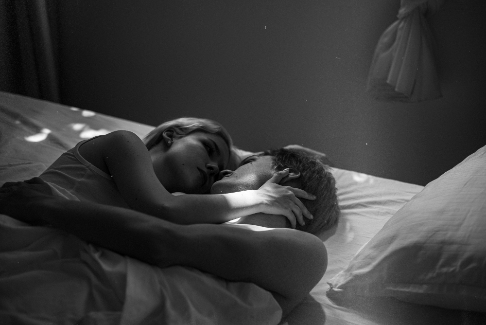 High angle cute couple laying in bed