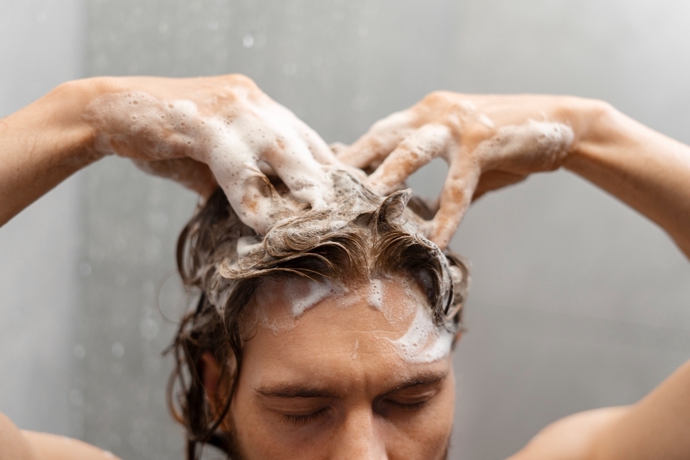 Man giving himself scalp massage