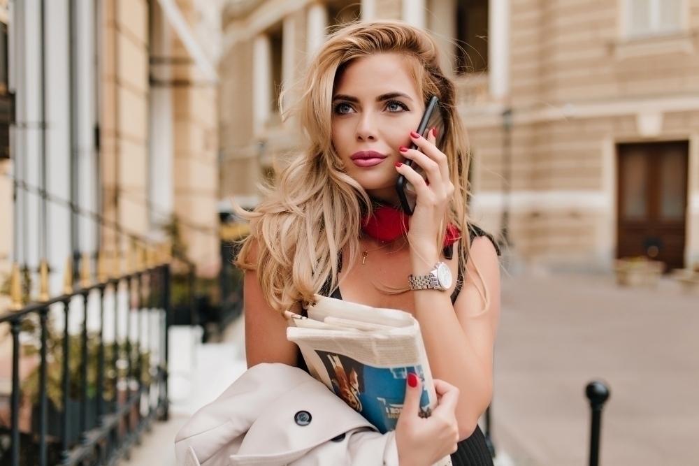 Romantic blonde woman calling friend to invite her to spending time together