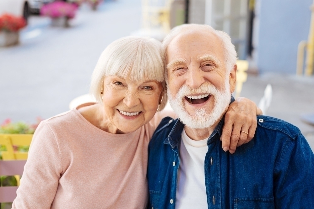 Senior couple making laugh and looking at camera